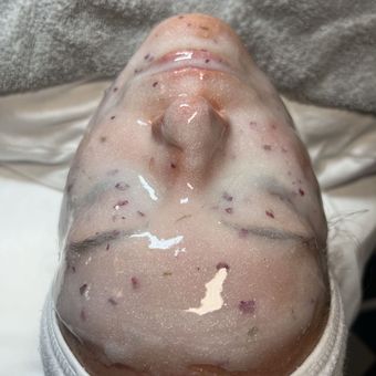 A jelly mask flecked with dried botanicals, smoothed over the face and left to set.